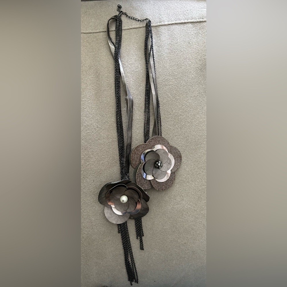 Long gunmetal chain and leather metallic piece necklace. Pearl bead embellished
